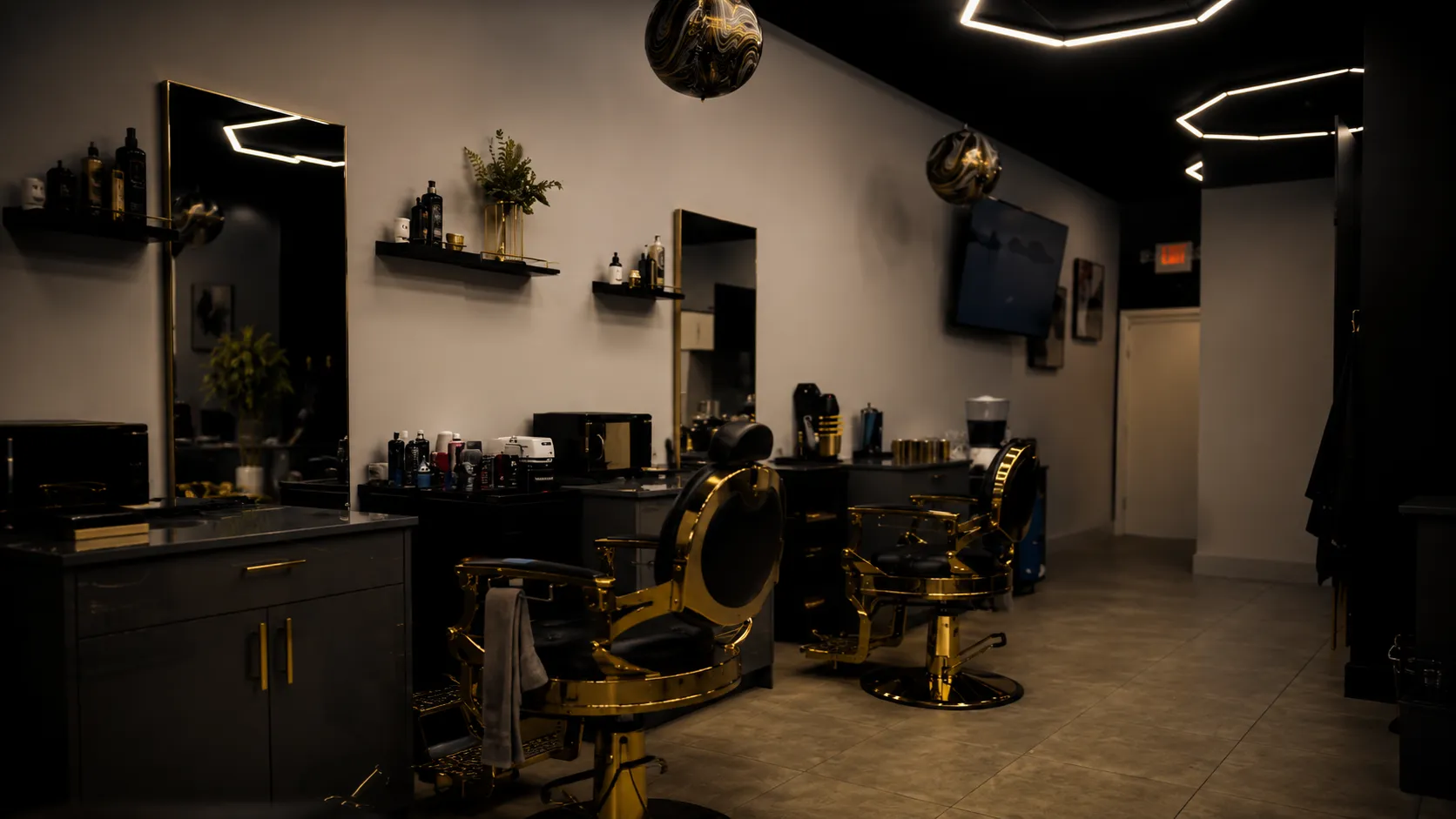 Interior of Who's Next Barber Shop in Boca Raton featuring custom gold chairs and modern hexagonal lighting